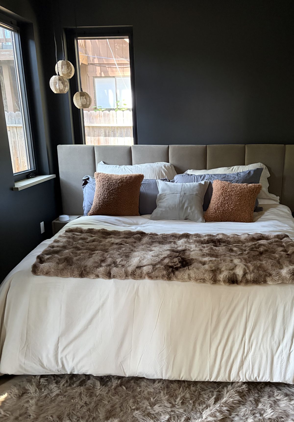 Downstairs master bedroom with a king bed and dark walls